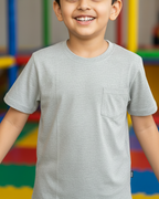 Child wearing a gray t-shirt in front of a colorful background