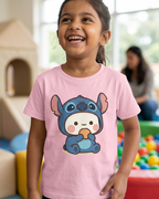 Child wearing a pink t-shirt with a cartoon character in a playroom