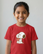 Child wearing a red t-shirt with a cartoon character on a plain background