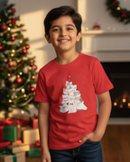 Child wearing a red t-shirt with a cat graphic in a festive room with Christmas decorations.