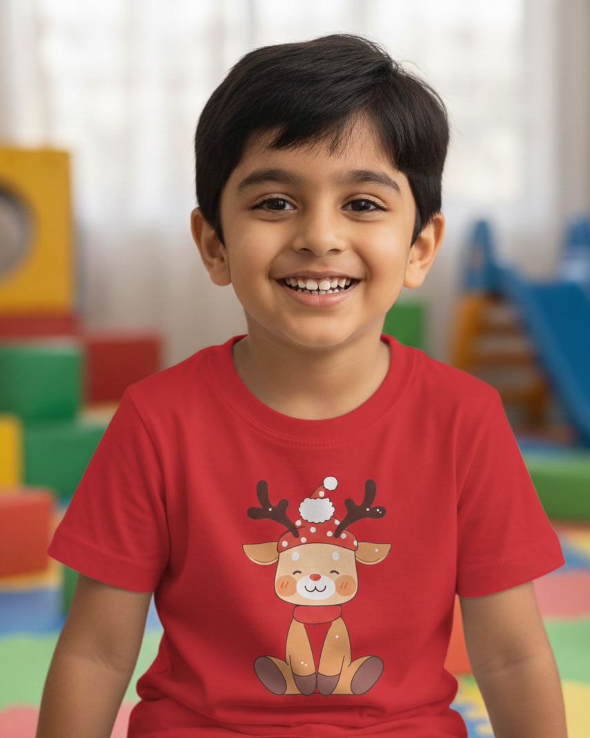 Child wearing a red t-shirt with a reindeer design in a colorful indoor setting