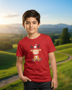 Child wearing a red t-shirt with a reindeer design in a scenic outdoor setting
