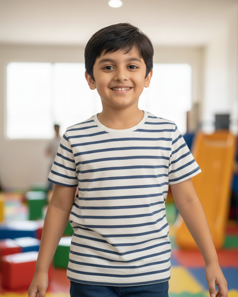 Child wearing a striped shirt in a colorful classroom setting