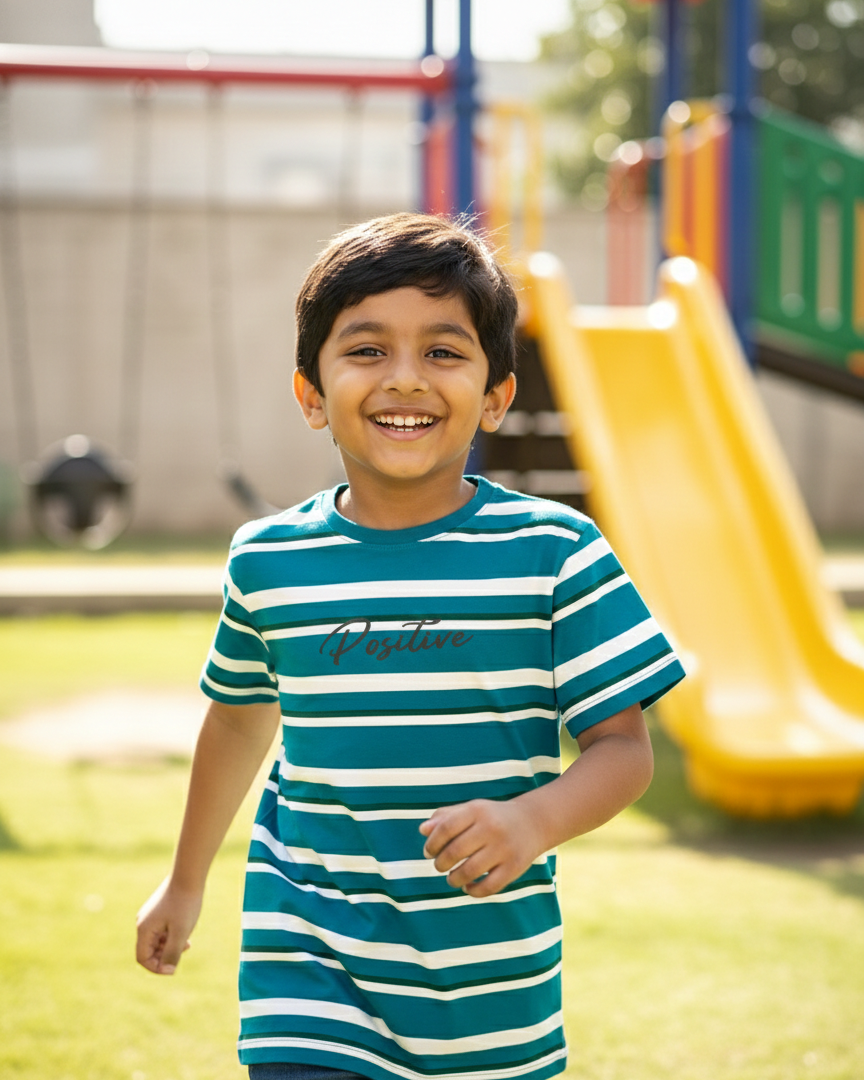 Child wearing a striped shirt with playground equipment in the background.