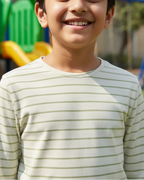 Child wearing a striped shirt with playground equipment in the background