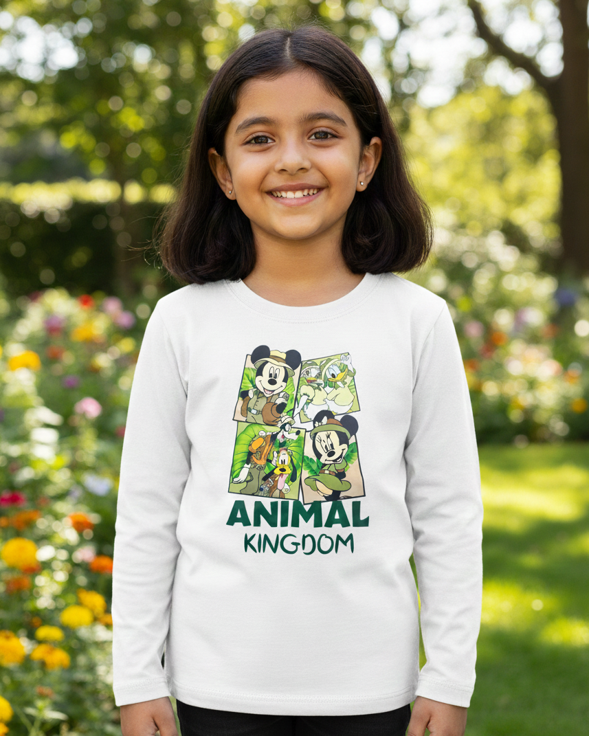 Child wearing a white long-sleeve shirt with 'Animal Kingdom' design in a garden setting