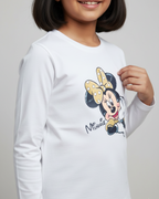 Child wearing a white long-sleeve shirt with Minnie Mouse graphic