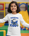 Child wearing a white long-sleeve shirt with a cartoon character and text in a colorful indoor setting.