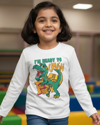 Child wearing a white long-sleeve shirt with a dinosaur graphic and text in an indoor play area.