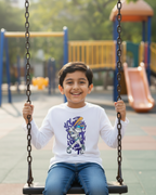 Child wearing a white long-sleeve shirt with a graphic design in a playground background.