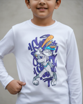 Child wearing a white long-sleeve shirt with a graphic design in a white and grey background.