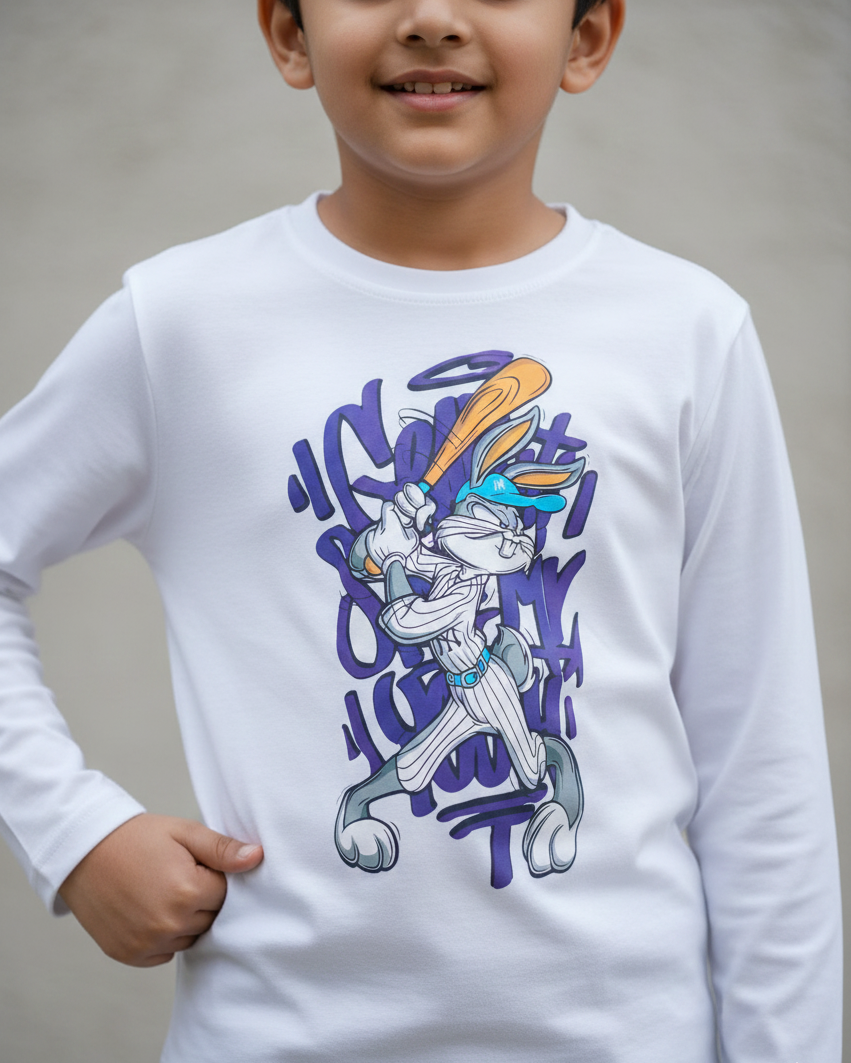 Child wearing a white long-sleeve shirt with a graphic design in a white and grey background.