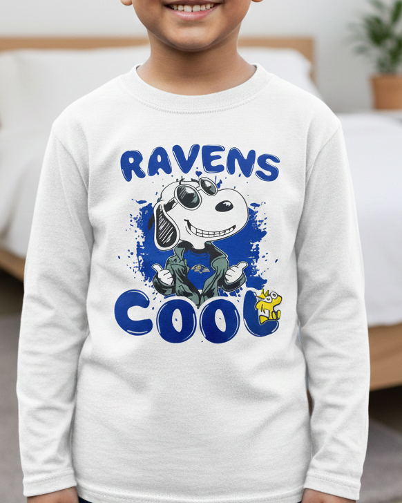 Child wearing a white sweatshirt with 'Ravens Cool' text and graphic in a bedroom setting