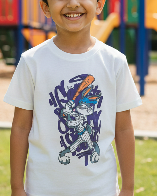 Child wearing a white t-shirt with a colorful graphic design on a playground background