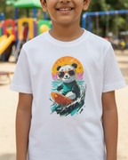 Child wearing a white t-shirt with a colorful panda graphic in an outdoor playground setting