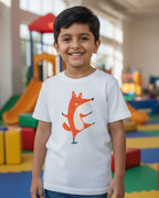 Child wearing a white t-shirt with a fox graphic in an indoor playground setting