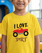 Child wearing a yellow t-shirt with 'I Love Dirt' graphic in a colorful indoor setting