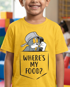 Child wearing a yellow t-shirt with a cartoon character and text saying where is my food in a colorful indoor setting