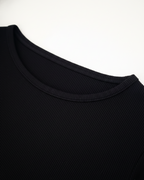 Close-up of a black sweater collar on a white background