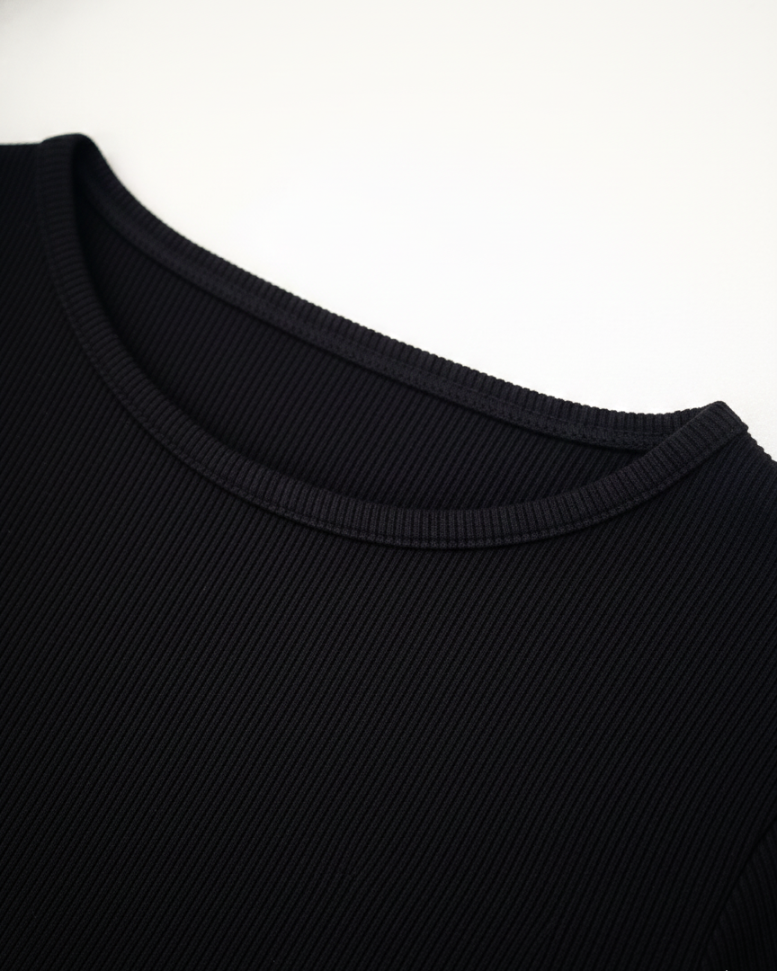 Close-up of a black sweater collar on a white background