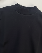 Close-up of a dark blue garment with a collar on a white background