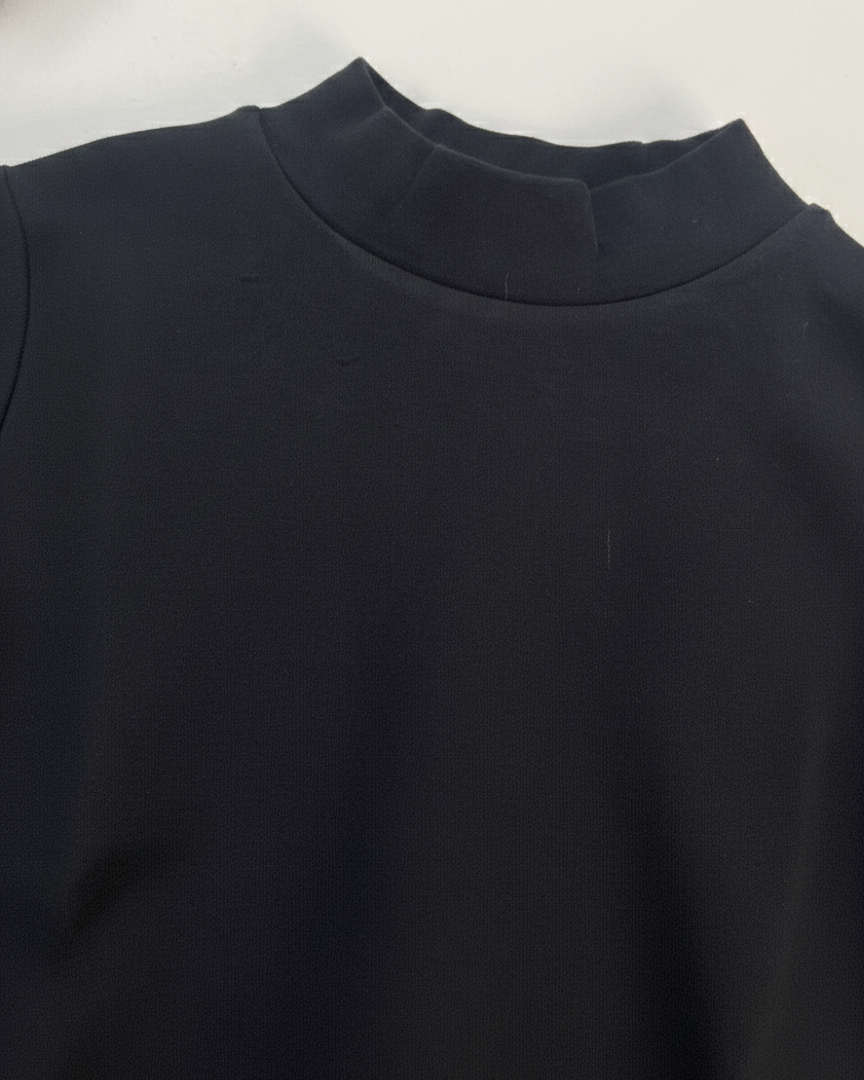 Close-up of a dark blue garment with a collar on a white background