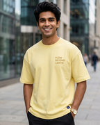 A Young Man wearing a Flow Beyond Limits with Pastel Yellow Oversized T-shirt