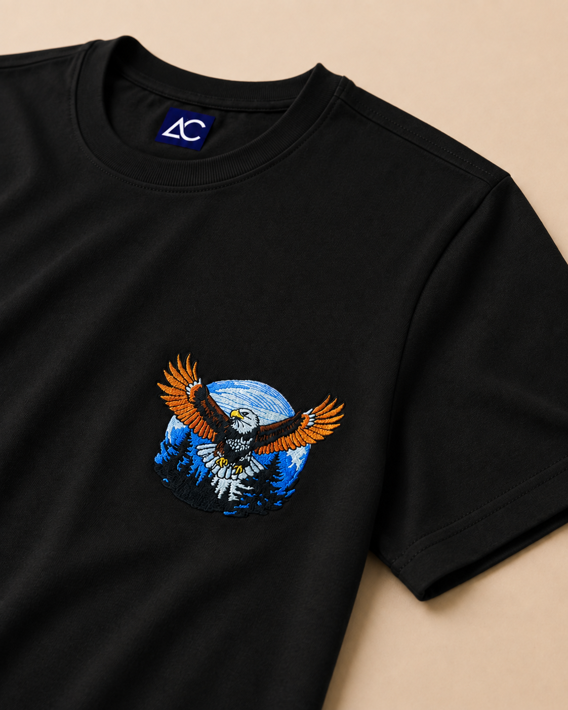Focus view of Eagle embroidered Black Regular Fit T-shirt placed on the Light Beige background