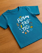 Girl wearing a Funtasctic print in Kids Teal Blue T-shirt placed on wooden background