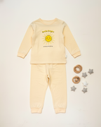 Yellow children's pajama set with a sun design on a light gray background