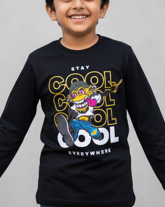 Child wearing a black long-sleeve shirt with a graphic design on a gray background