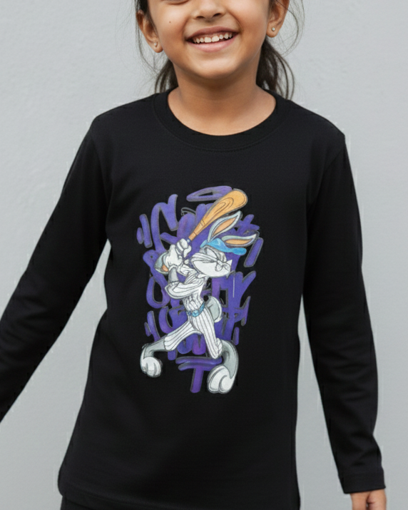 Girl wearing a black long-sleeve shirt with a graphic design on a gray background