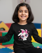 Girl wearing black rabbit T-shirt in indoor playground background.