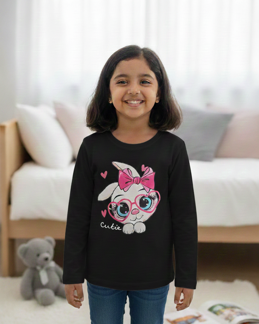 Girl wearing black rabbit T-shirt in minimalist bedroom background.