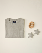 Gray sweater with a brand label on a light beige background