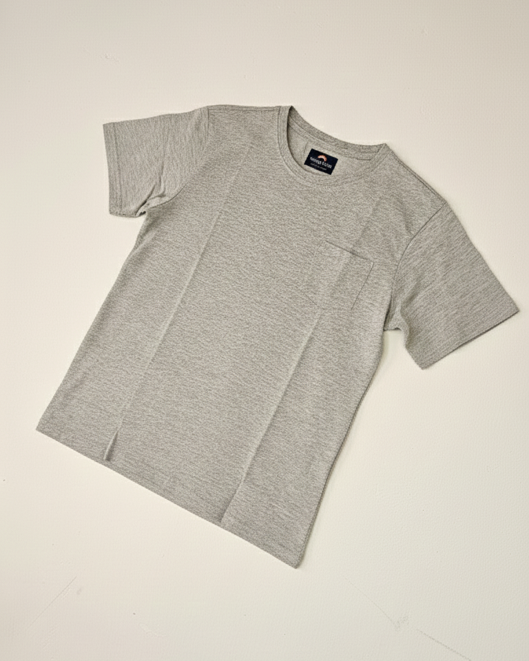 Gray t-shirt with a brand logo on a light beige background