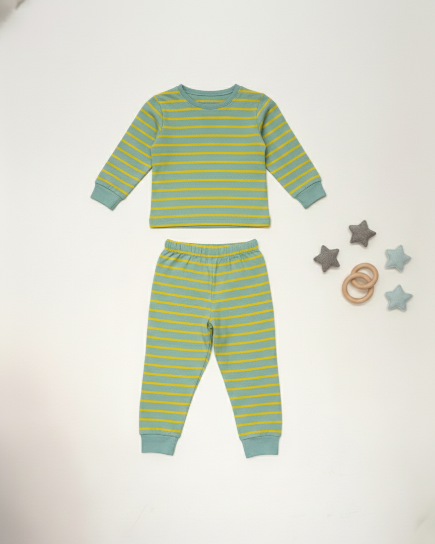 Green and blue striped pajama set on a white background with wooden toys.