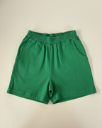 Green shorts on a beige background