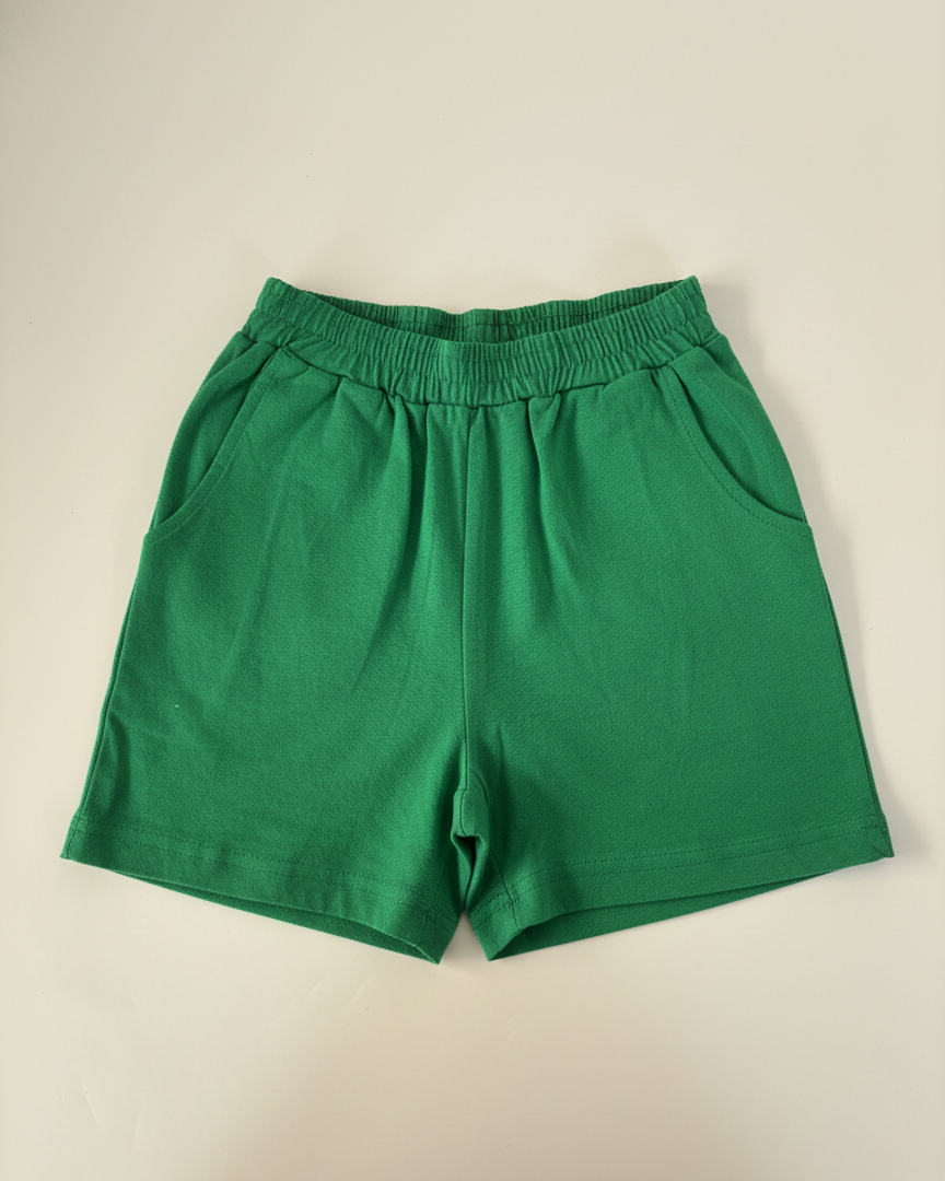 Green shorts on a beige background