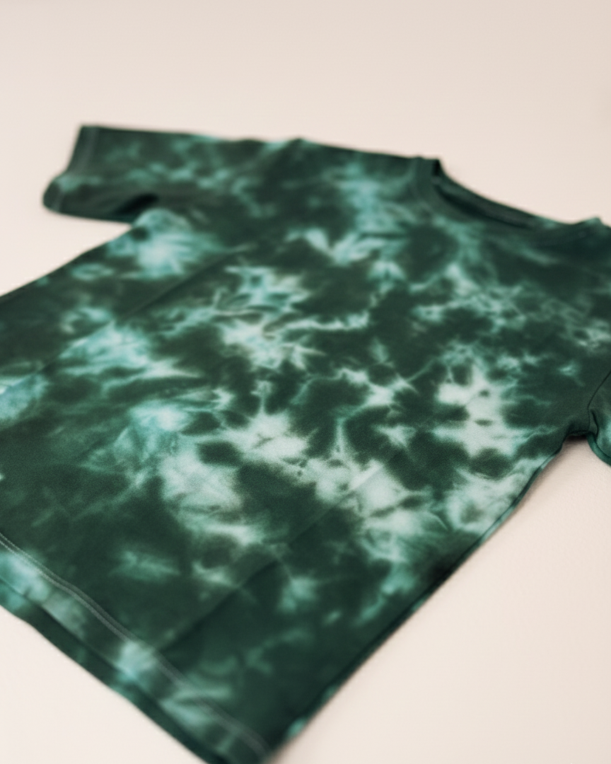Green tie-dye shirt on a light beige background