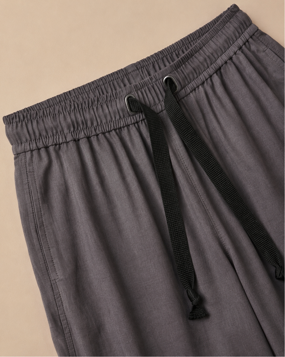 Grey Palazzo Pant closeup view laid on the beige background