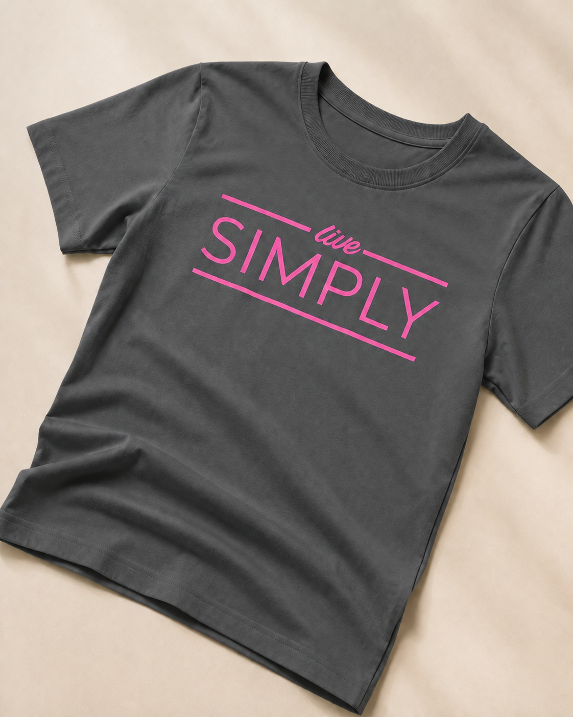 Grey T-shirt with Live Simply print close view of the print  placed on light beige background