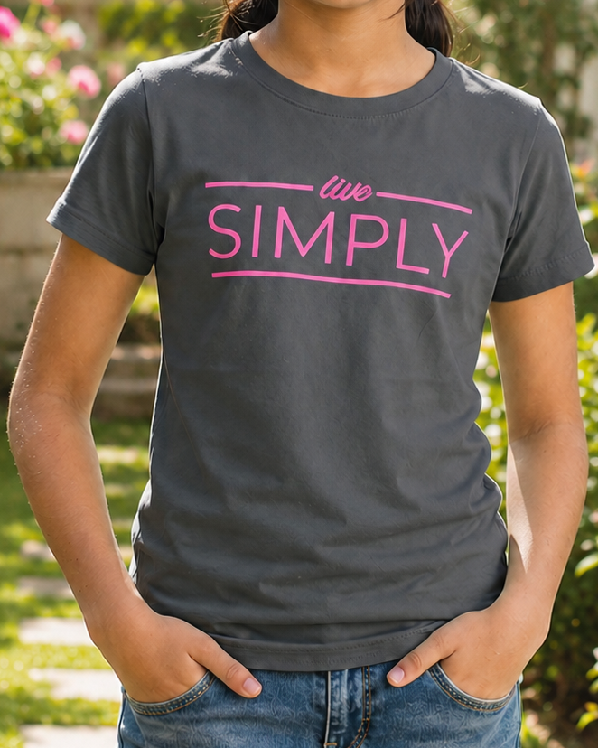 Girl wearing a Grey T-shirt with Live Simply print standing in garden