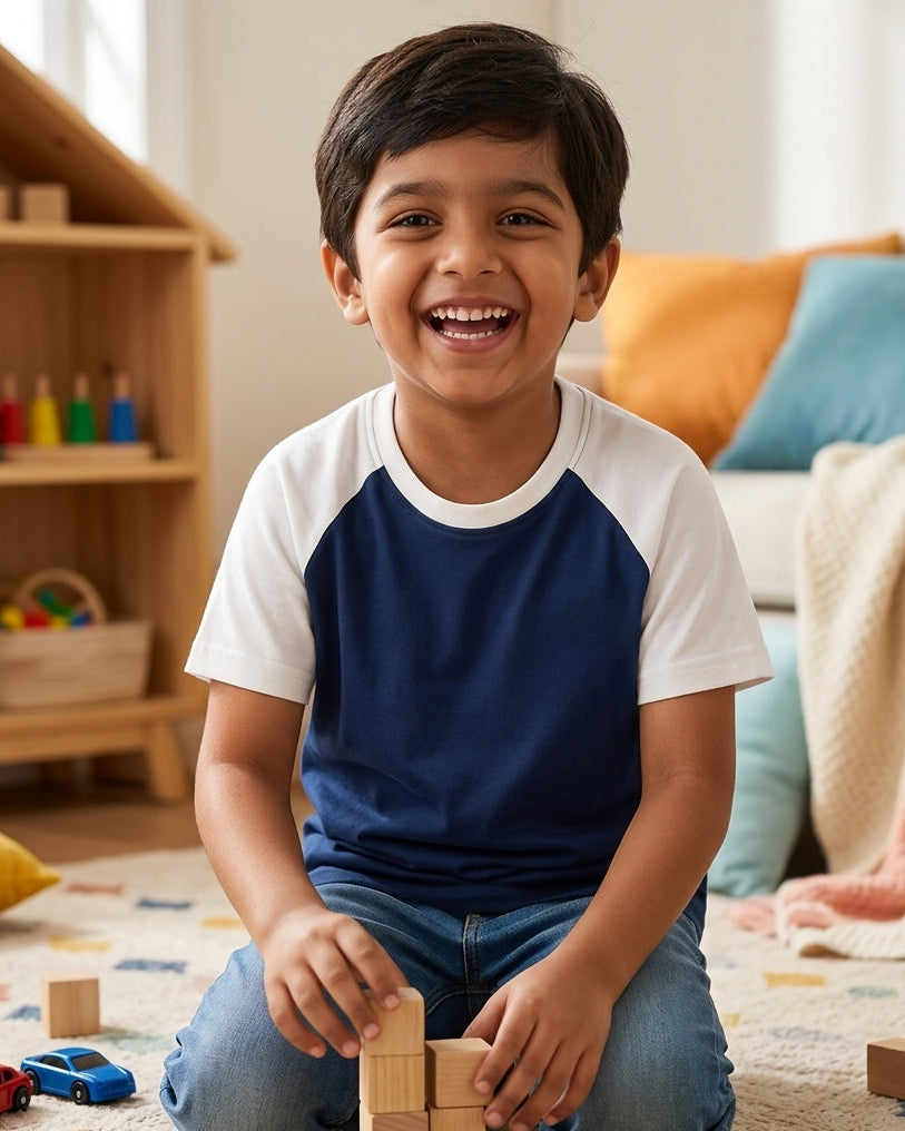 A boy wearing a Raglan Sleeve T-Shirt and playing Indoor games