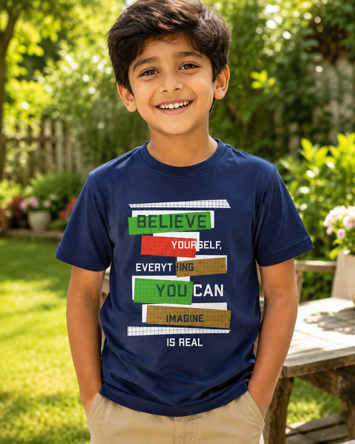 Boy wearing a Navy T-shirt with Believe yourself print