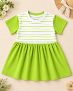 Comfortable kids’ frock featuring a striped bodice, contrast green sleeves, and a soft gathered skirt placed on the light beige background