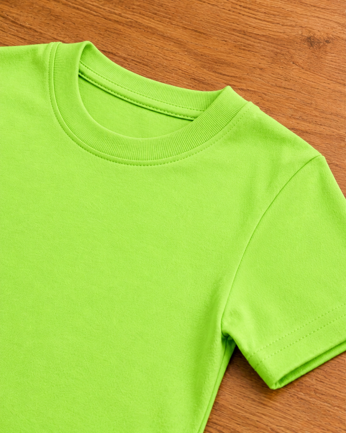 Light Lime Green T shirt  placed on the wooden background close view