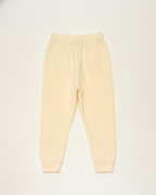 Light yellow sweatpants on a white background