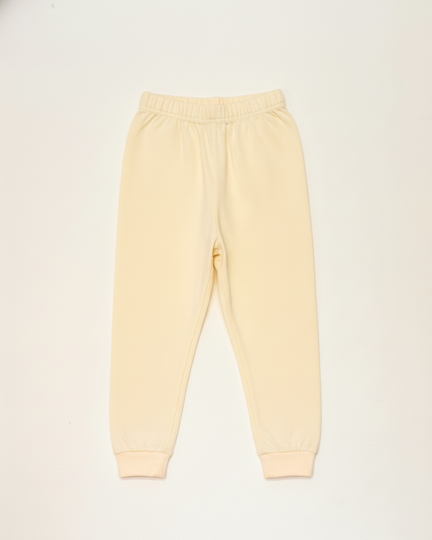 Light yellow sweatpants on a white background