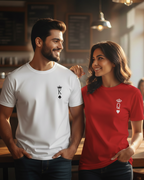Man and woman wearing t-shirts with king and queen designs in a cafe setting